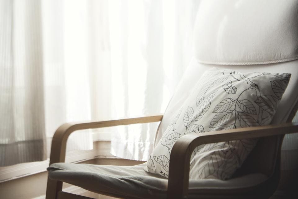Photograph of plump pillows arranged on a cozy bed