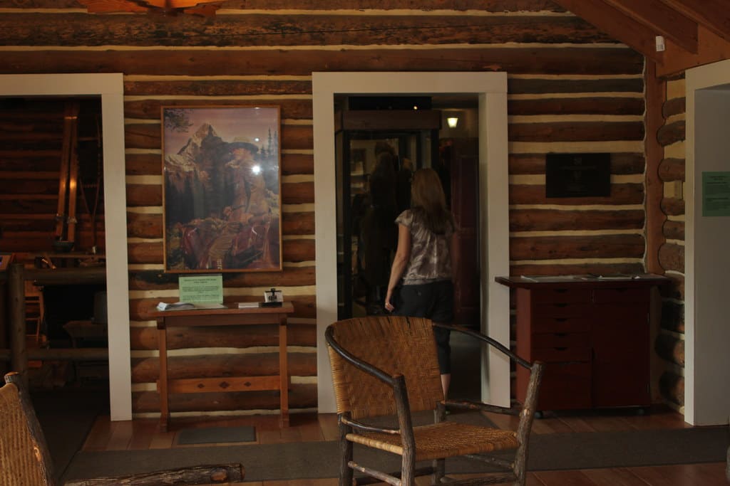 Photograph of a tidy home entryway with a console, mirror, and shoes by the door